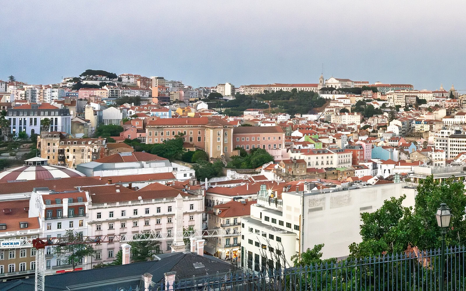 Lisbon's terracotta rooftops and hills at dusk from Miradouro da Senhora do Monte